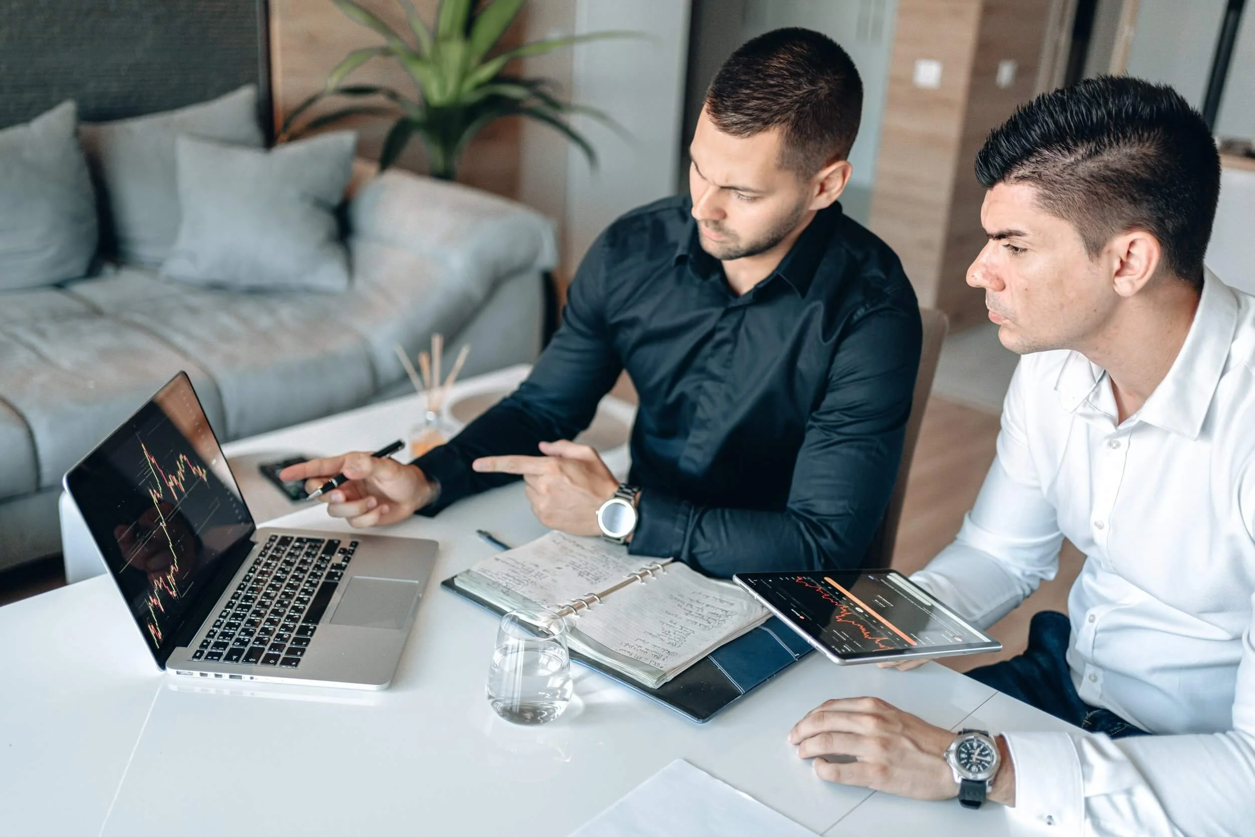 Two Men Looking At Charts On A Computer for Soluntech's Modern Go To Market Guide